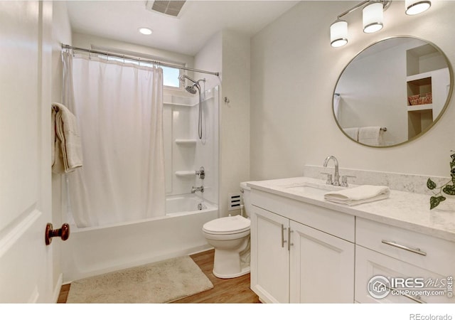 bathroom featuring toilet, shower / tub combo, wood finished floors, visible vents, and vanity