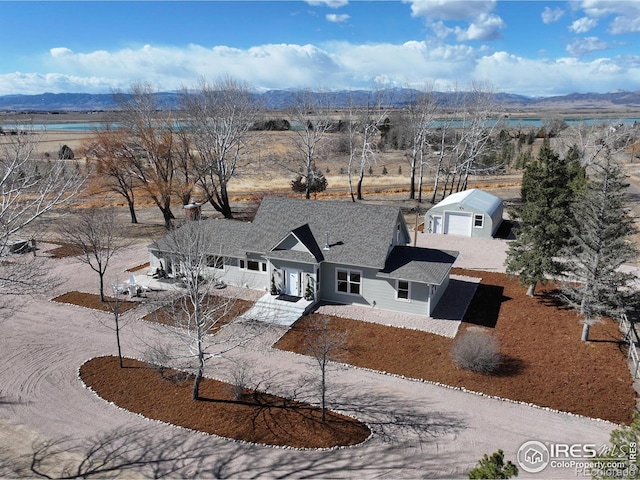 view of front of property with driveway and a mountain view