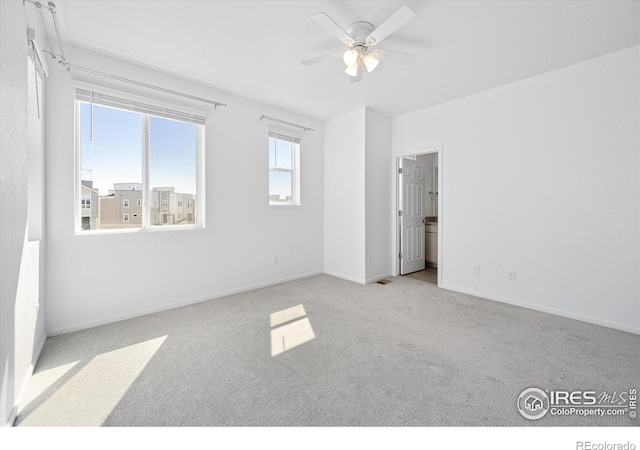 unfurnished bedroom featuring carpet, baseboards, and ceiling fan