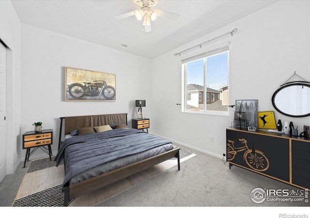 carpeted bedroom with a ceiling fan and baseboards