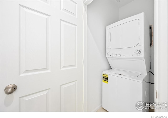 washroom with laundry area and stacked washer / dryer