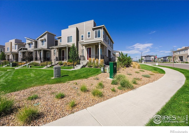 view of front of home with a front yard and a residential view