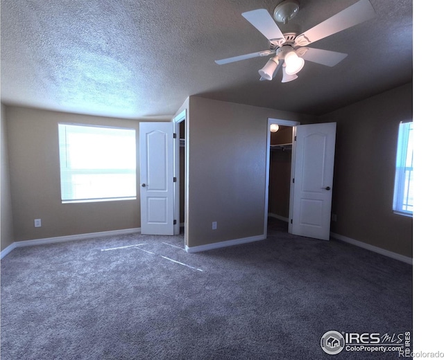 unfurnished bedroom with a ceiling fan, a textured ceiling, baseboards, and carpet flooring