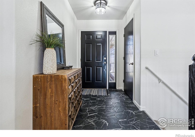 foyer entrance featuring marble finish floor