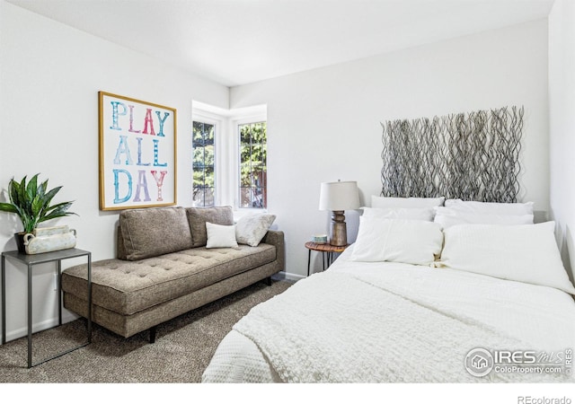 carpeted bedroom featuring baseboards