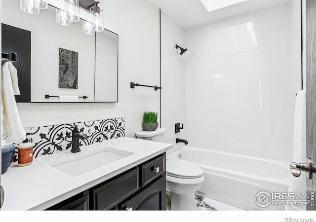 bathroom with vanity, toilet, and shower / bathtub combination