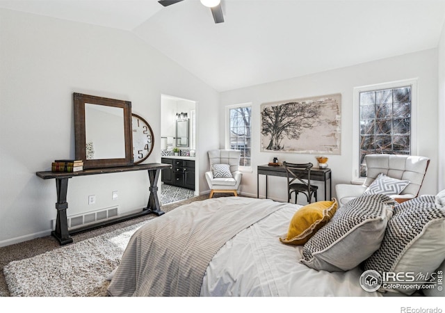 bedroom with lofted ceiling, carpet flooring, visible vents, baseboards, and ensuite bath