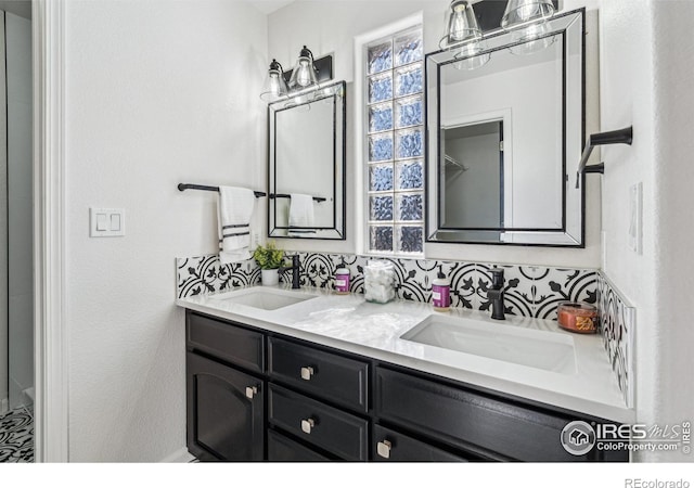 full bathroom featuring double vanity and a sink