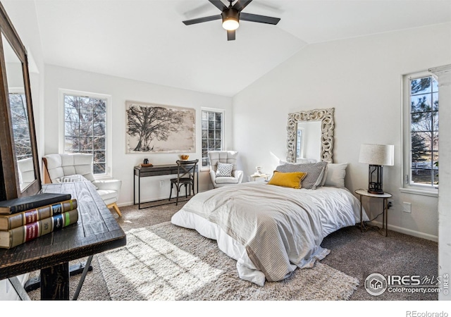 carpeted bedroom featuring vaulted ceiling, multiple windows, a ceiling fan, and baseboards