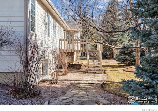 view of yard with stairway and a wooden deck