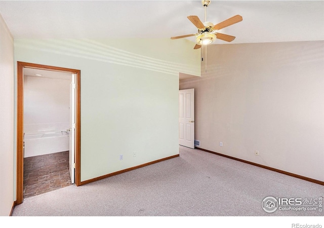 carpeted empty room featuring high vaulted ceiling, ceiling fan, and baseboards