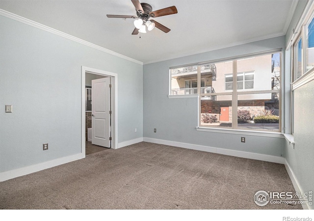 carpeted empty room with a healthy amount of sunlight, baseboards, and ornamental molding