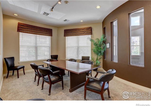 home office featuring light carpet, baseboards, and visible vents