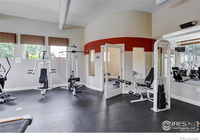 exercise room featuring plenty of natural light and baseboards