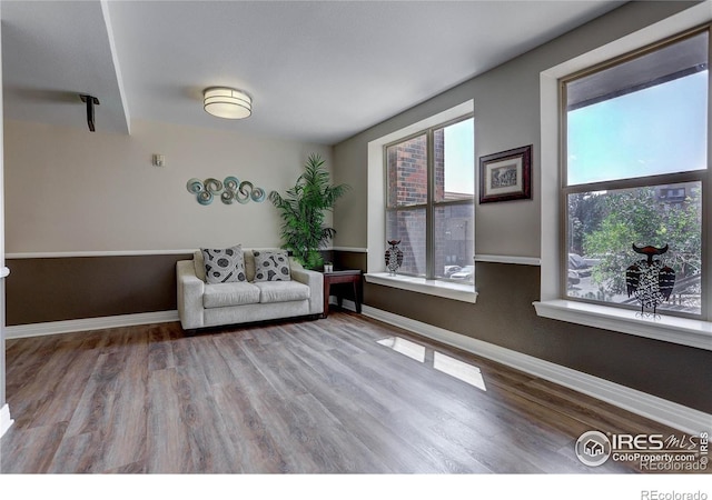 unfurnished room featuring baseboards and wood finished floors