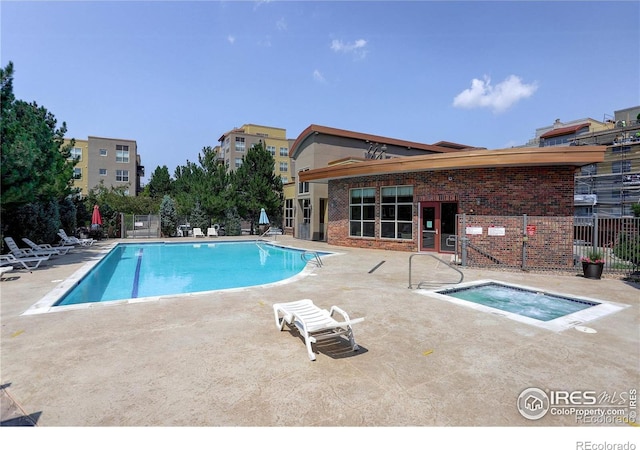 community pool with a community hot tub, a patio area, and fence