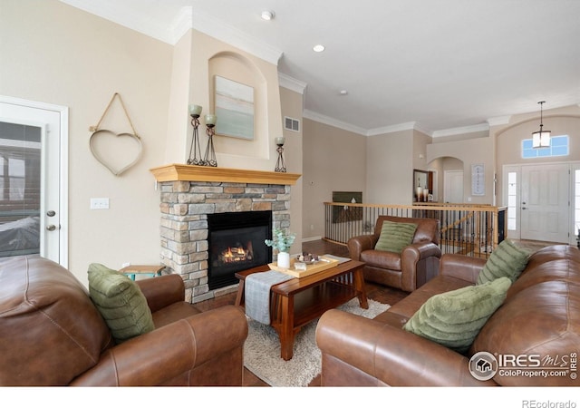 living area with crown molding, recessed lighting, visible vents, and a fireplace