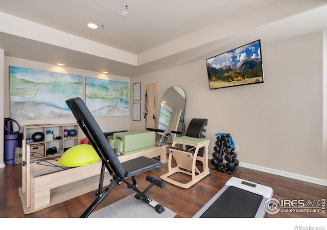 workout area with baseboards, wood finished floors, and recessed lighting