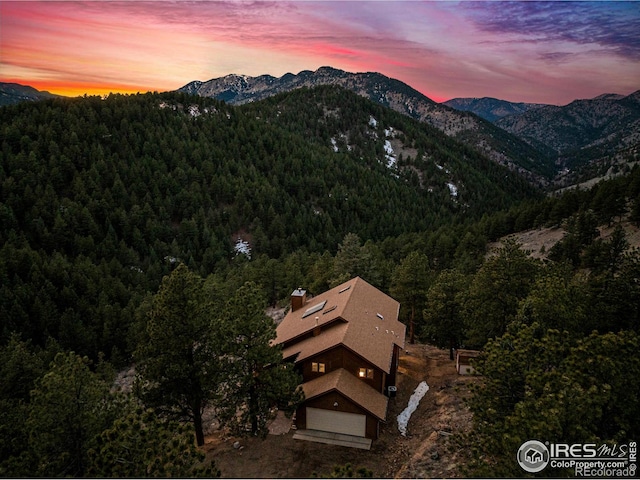 exterior space featuring a view of trees and a mountain view