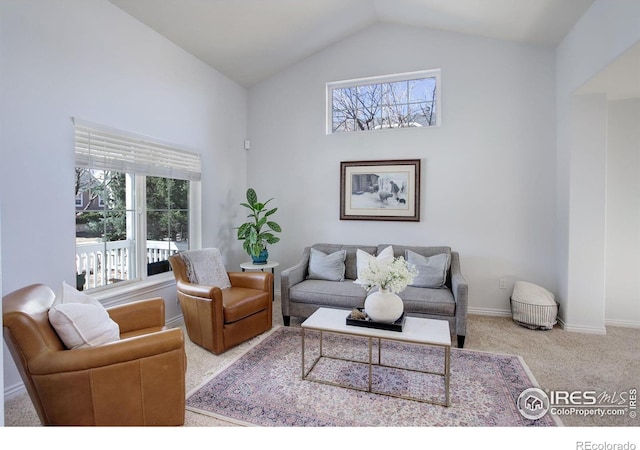 carpeted living room with high vaulted ceiling and baseboards