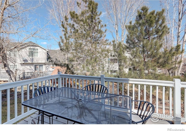 wooden terrace featuring outdoor dining area