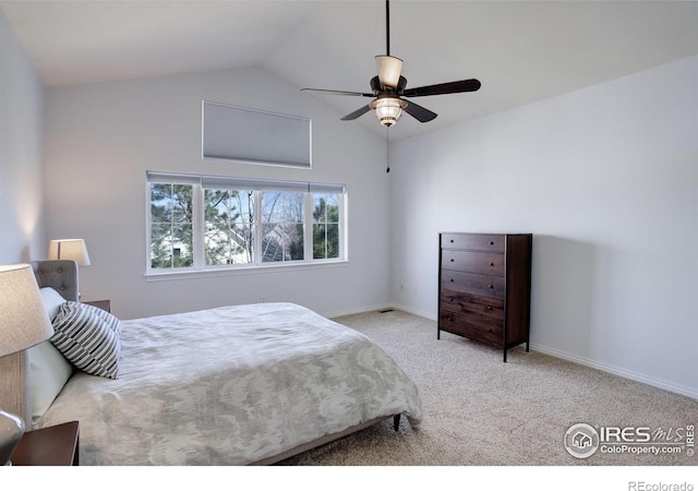 carpeted bedroom with baseboards, vaulted ceiling, and a ceiling fan