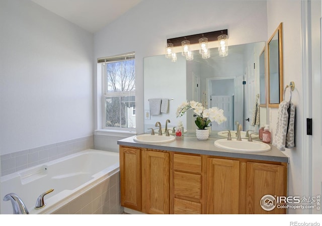 bathroom featuring a garden tub, a sink, and double vanity