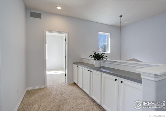 hallway featuring recessed lighting, visible vents, light carpet, and baseboards