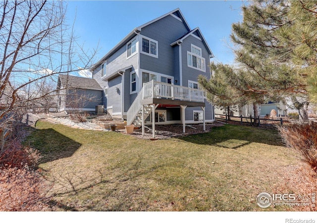 rear view of house featuring stairs, fence, a deck, and a yard