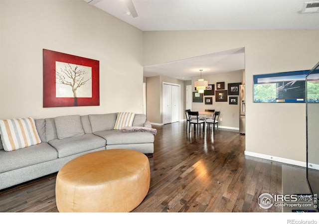 living room with lofted ceiling, wood-type flooring, visible vents, and baseboards