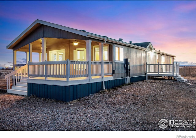 view of front of property featuring ceiling fan and a deck