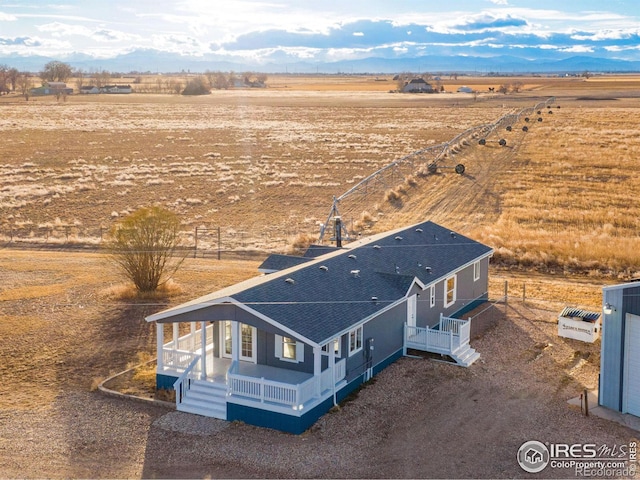 birds eye view of property with a rural view