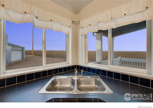 interior details with dark countertops and a sink