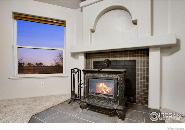 room details featuring a tile fireplace