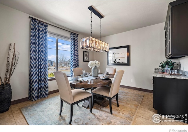 dining area with light tile patterned floors and baseboards