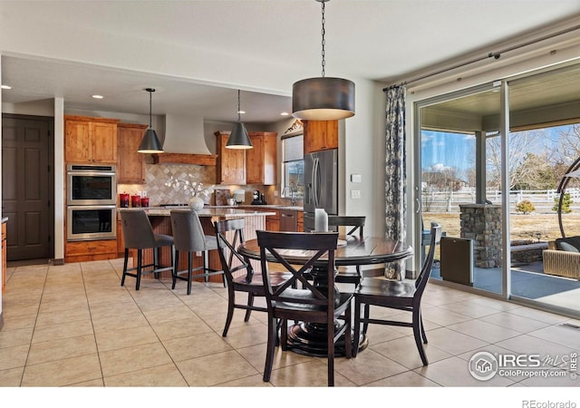 dining space with recessed lighting and light tile patterned floors