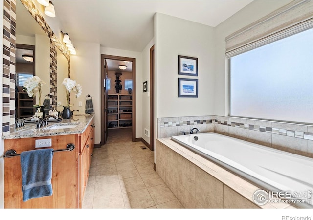 full bath with vanity, a bath, and tile patterned floors