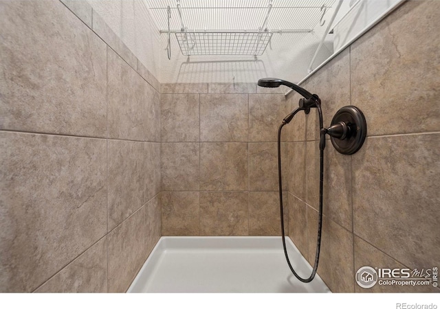 bathroom with tiled shower