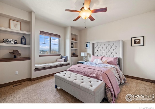 bedroom with carpet floors, baseboards, visible vents, and a ceiling fan