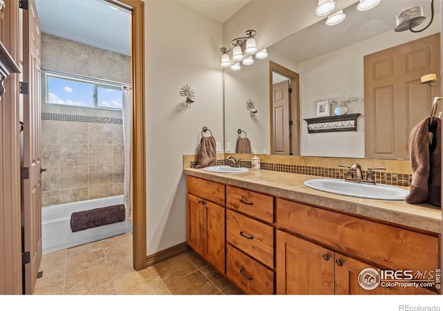 full bathroom featuring double vanity,  shower combination, a sink, and tile patterned floors