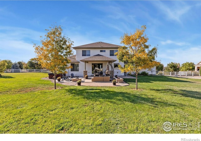 back of property with fence, a lawn, and a patio