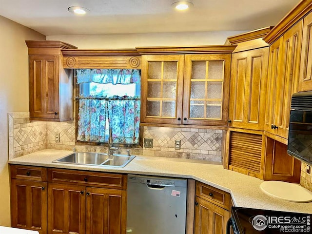 kitchen featuring black microwave, stove, a sink, light countertops, and dishwasher