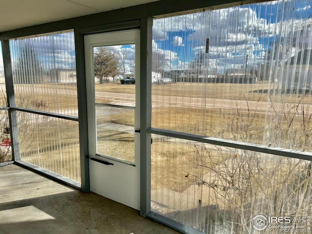 doorway with plenty of natural light and concrete floors