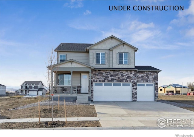 craftsman inspired home with covered porch, driveway, stone siding, and an attached garage