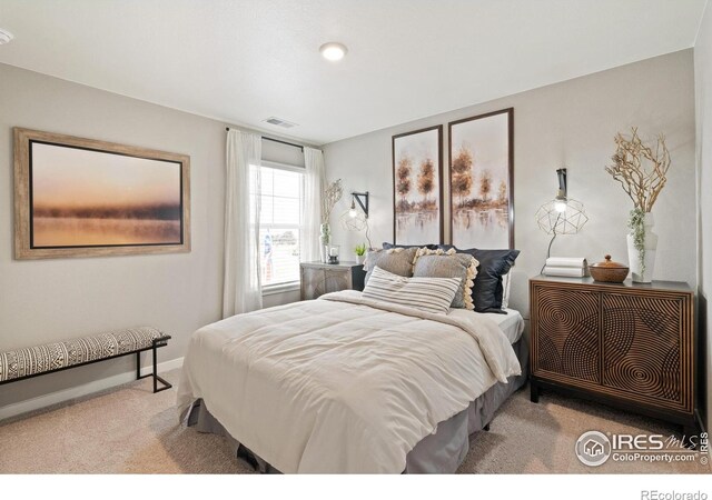 carpeted bedroom with visible vents and baseboards