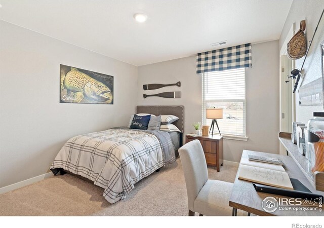 carpeted bedroom featuring visible vents and baseboards