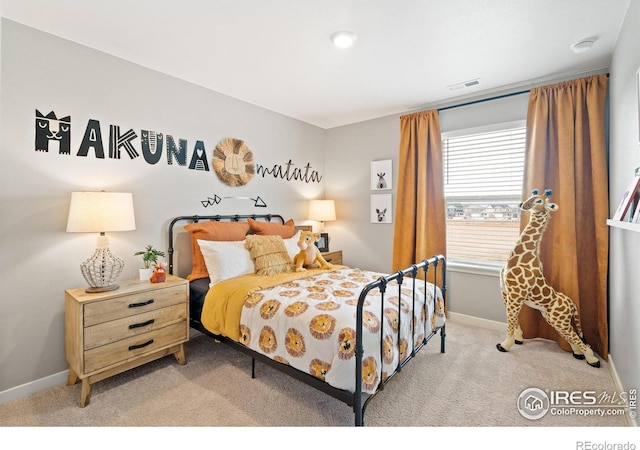 carpeted bedroom featuring baseboards and visible vents