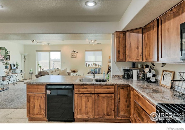 kitchen with black dishwasher, brown cabinetry, open floor plan, a peninsula, and a sink