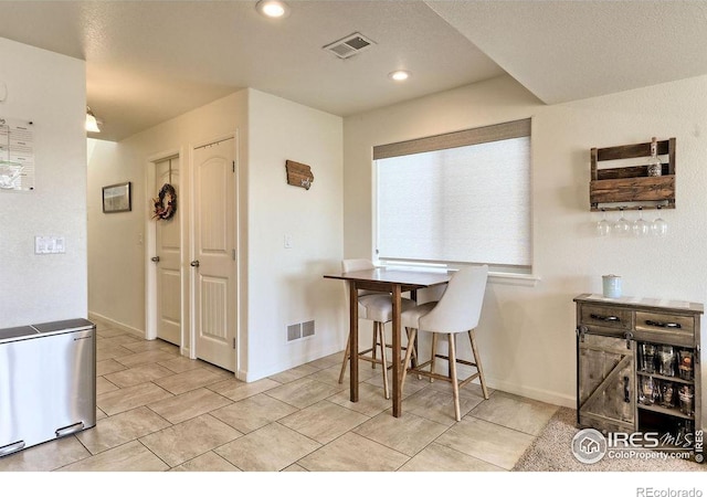 dining room featuring baseboards, visible vents, and recessed lighting