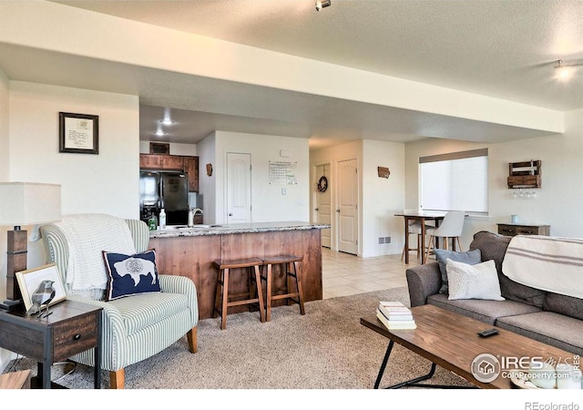 living room with light tile patterned floors and a textured ceiling